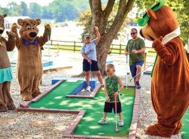 Yogi Bear and friends playing mini golf at a Jellystone campground