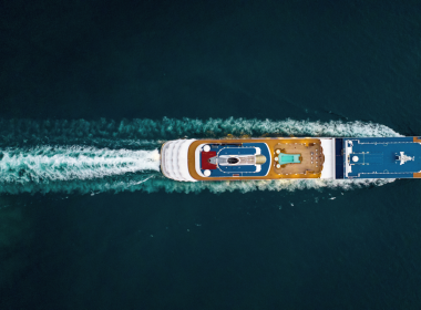 Cruise ship sailing through the water with wake.