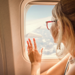 Woman looking out window on an airplane.