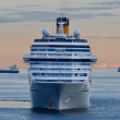A cruise ship with at dusk sailing.