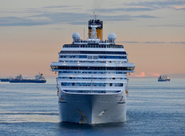 A cruise ship with at dusk sailing.