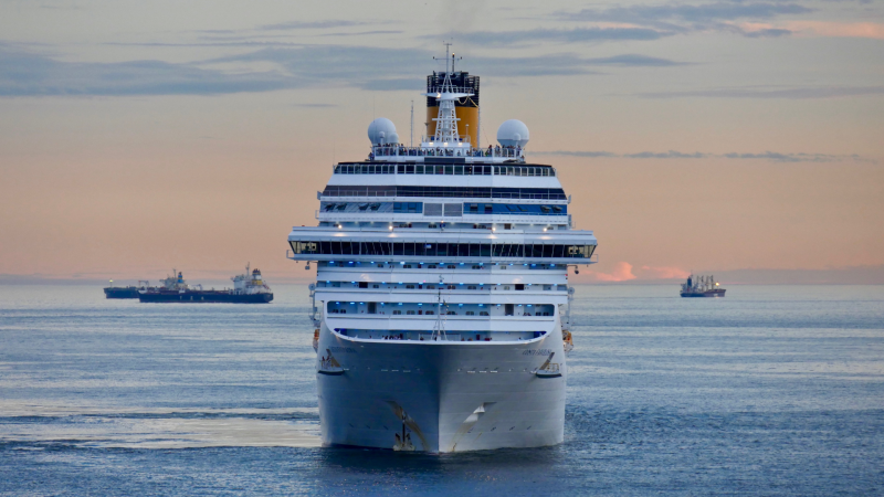 A cruise ship with at dusk sailing.