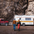 The Endless Adventure facing their Coachmen RV Motorhome with their Red Jeep being towed behind it.