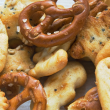 Snack mix of crackers and pretzels against a white background.