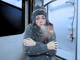 Colder person with full winter gear on, in an RV Bathroom
