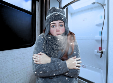 Colder person with full winter gear on, in an RV Bathroom