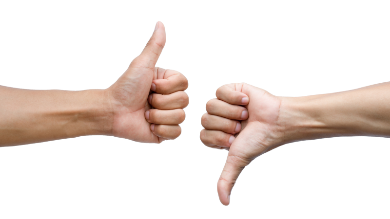 Two hands, one with their thumb up and the other with their thumb down on a white background.