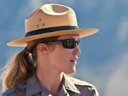 A close up photo of a female national park ranfer with an out of focus background.