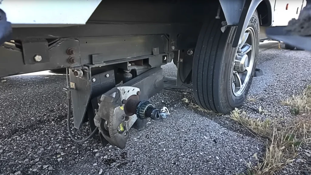 The missing RV tire and hub assembly from Irene Iron Travels RV as they are stopped on the side of the road.