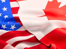 The U.S. flag on the left with the Canadian flag overlapping it on the right.