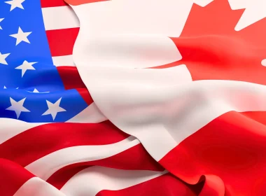 The U.S. flag on the left with the Canadian flag overlapping it on the right.