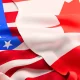The U.S. flag on the left with the Canadian flag overlapping it on the right.