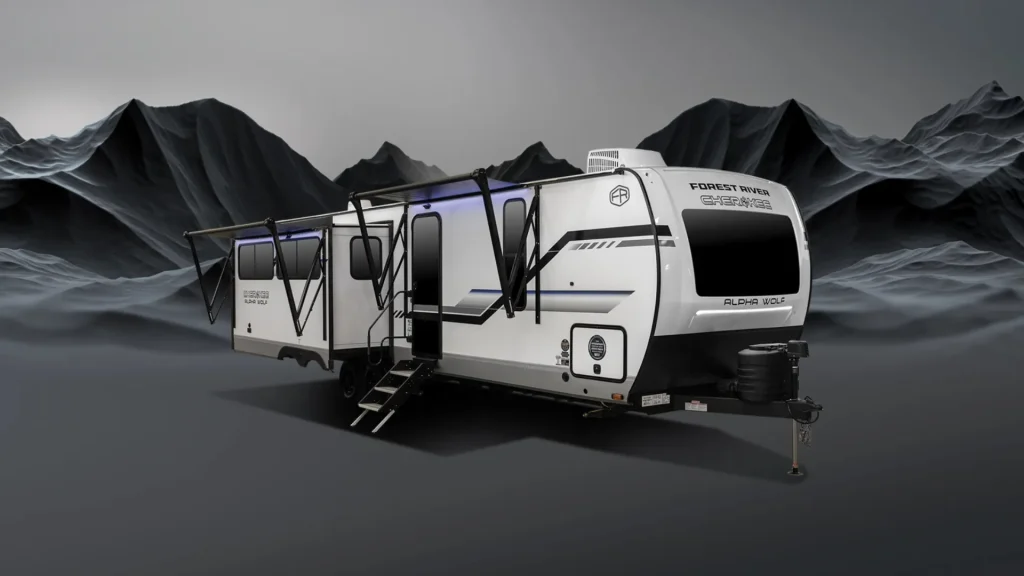 A forest river travel trailer set against a black and gray mountain range.