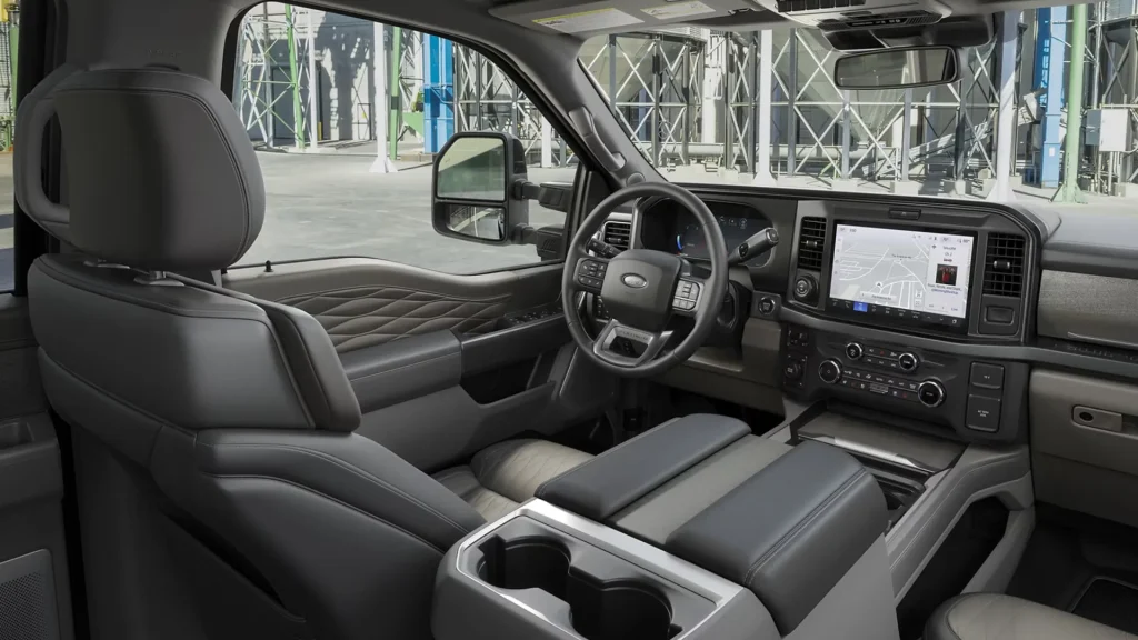 The interior of a Ford F-250 in beige and grey. Showing the updated dashboard, quilted detailing in the door panels, and more.