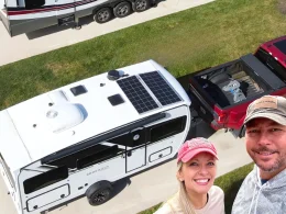 The duo behind Changing lanes in the corner layed over the top of an aerial of their RV trailers and red pick-up truck in two separate driveways.