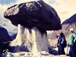 Ice Mushroom on Mount Tomür in July of 1977 on the South slope of MountTomür. This photo shows a giant ice mushroom on the Tailan glacier, Xiqiong, at a height of 4750 m. The weight of the gravel sustained by the ice column is about 5 tonnes.