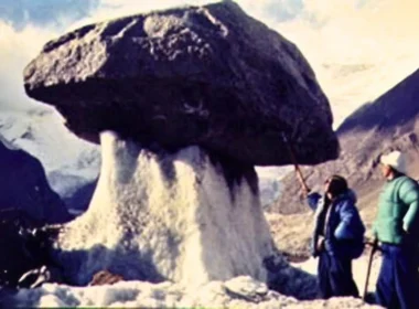 Ice Mushroom on Mount Tomür in July of 1977 on the South slope of MountTomür. This photo shows a giant ice mushroom on the Tailan glacier, Xiqiong, at a height of 4750 m. The weight of the gravel sustained by the ice column is about 5 tonnes.
