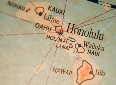 An aged map of Hawaii in sepia tones lays the islands and the ocean around it in a light blue.