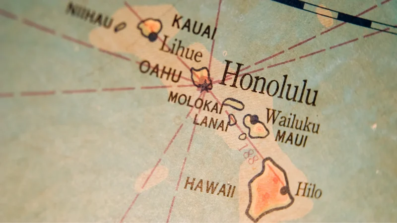 An aged map of Hawaii in sepia tones lays the islands and the ocean around it in a light blue.
