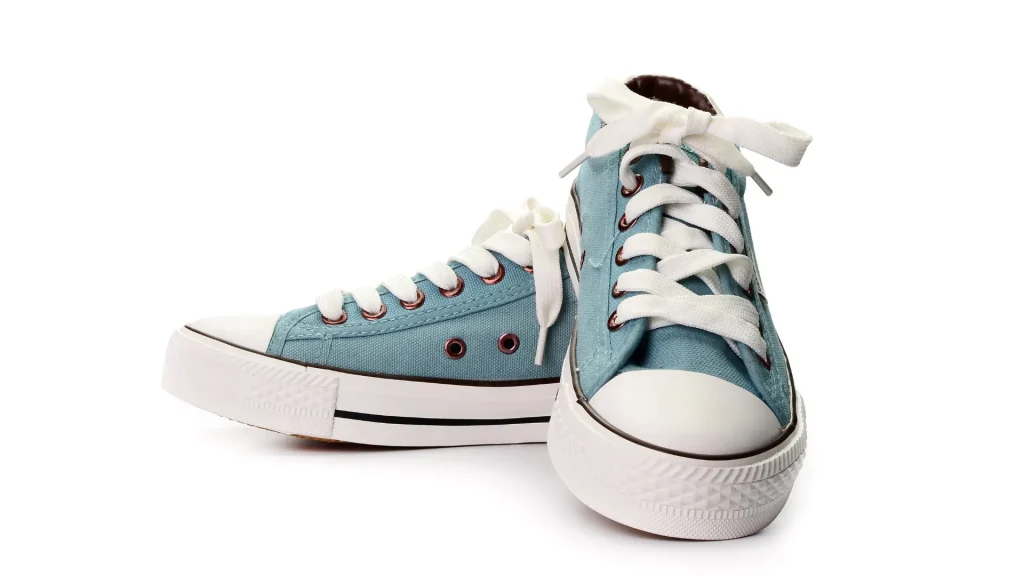 Teal blue sneakers with white laces, toe, and soles.