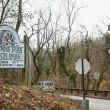 An image of the signage to Leakin Park and Gywnns Falls at the corner of a roadway.