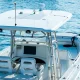 A recreational fishing boat on the ocean driving across the bright blue waters.