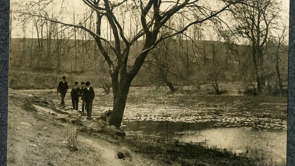 A vintage photo of Leakin Park in Baltimore, Maryland. It's is sepia toned and contains four gentlemen in the image.