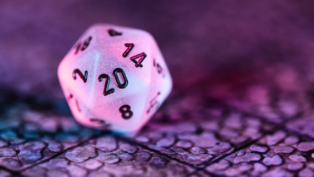 A 20-sided die, typically used in Dungeons and Dragons games in a pearlized color with purple lights casting down on it. It sits on a textured, gridded surface.