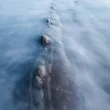 Long exposure of the oscean with a rib of a rock.