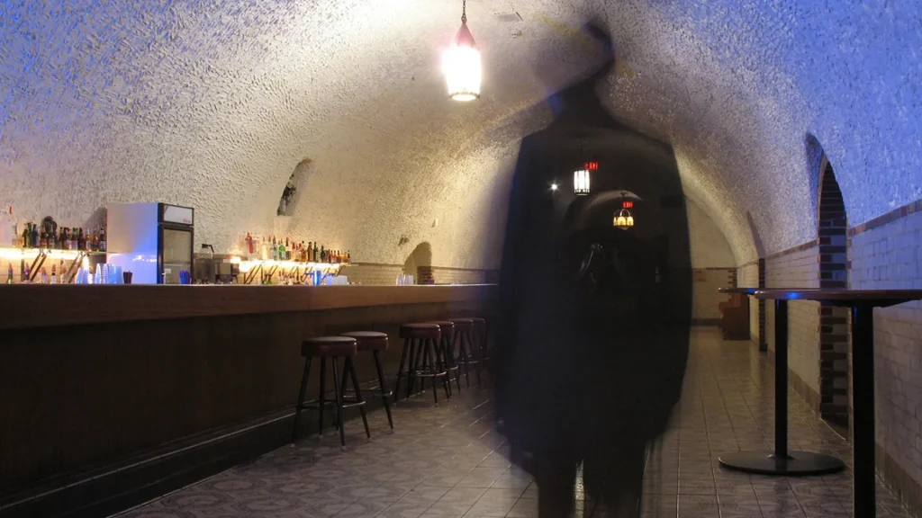 The Wabasha Street Caves bar with a shadowed figure standing in the middle of the room.